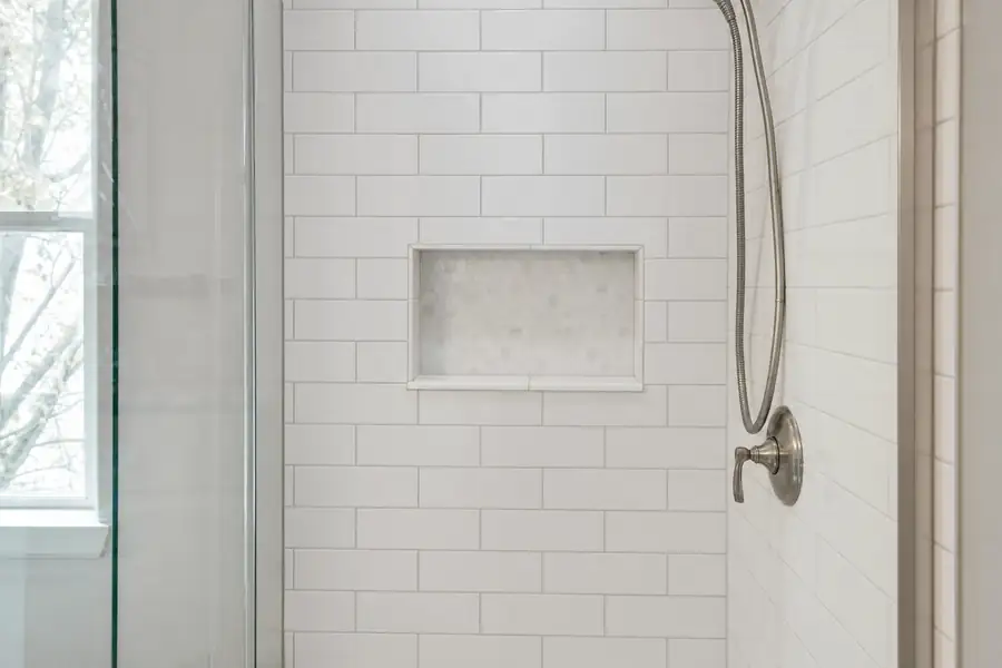 Sparkling white subway tile shower with bright, clean grout lines