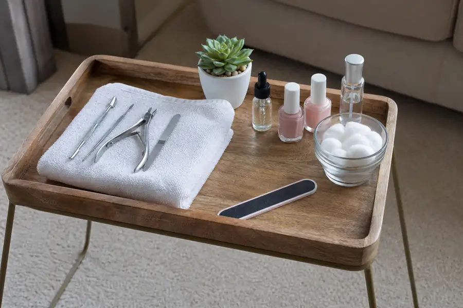 Manicure setup safely arranged on a tray table above clean carpet