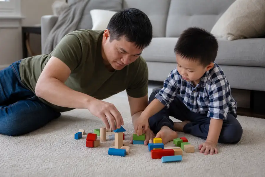 Parent and child playing with toys on a clean cream carpet